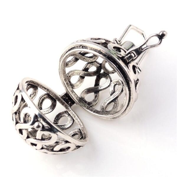 A pair of silver earrings with a round design.