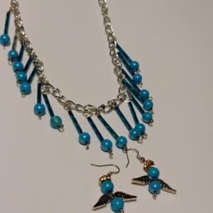 Silver necklace with blue bead charms hanging delicately.