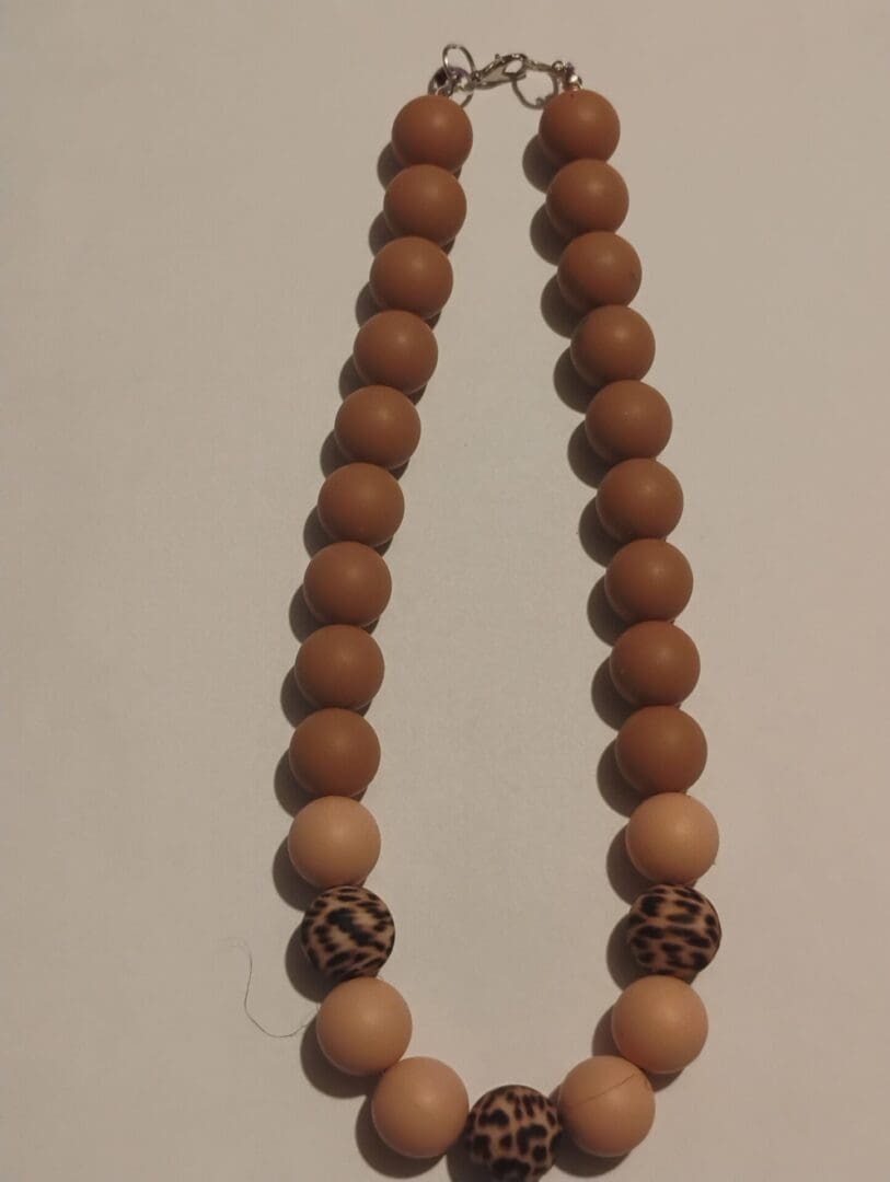 A wooden bead necklace with a simple design.