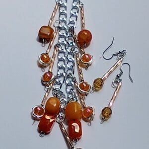 Handcrafted jewelry set with amber beads and silver chains.