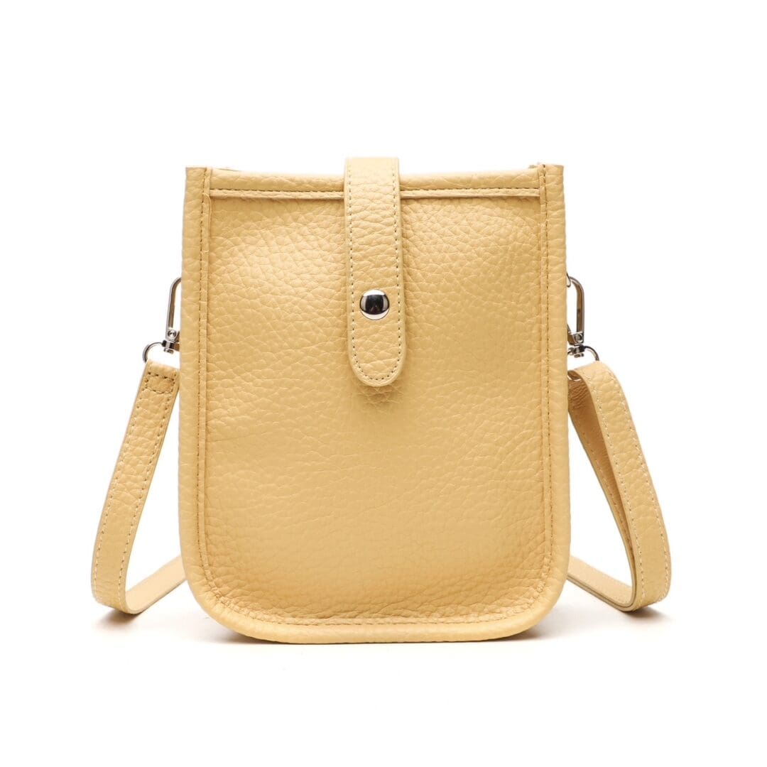 Small beige crossbody bag with a button clasp and adjustable strap.